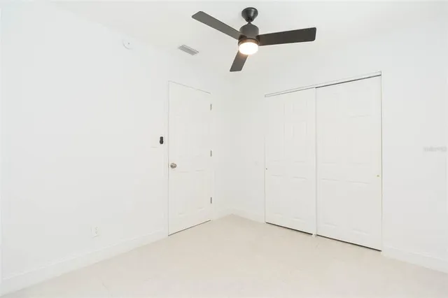 a view of a kitchen with a sink and dishwasher a refrigerator with white cabinets