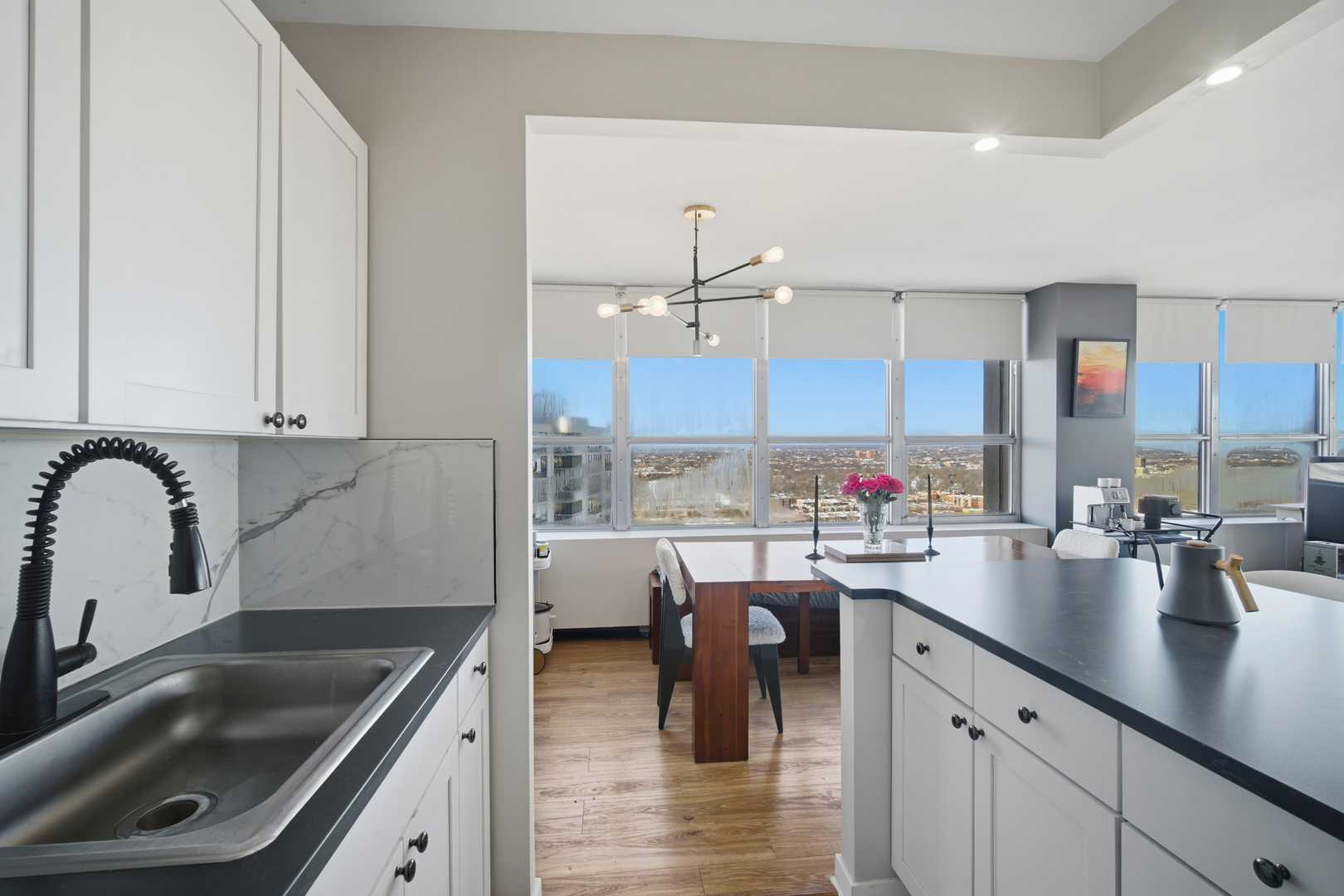 655 West Irving Park Road, Unit 2916 Chicago, IL 60613 - Photo 11 of 28 a kitchen with a sink a counter and chairs