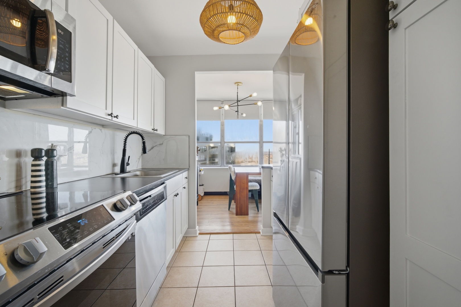 655 West Irving Park Road, Unit 2916 Chicago, IL 60613 - Photo 12 of 28 a kitchen with a sink and a stove top oven