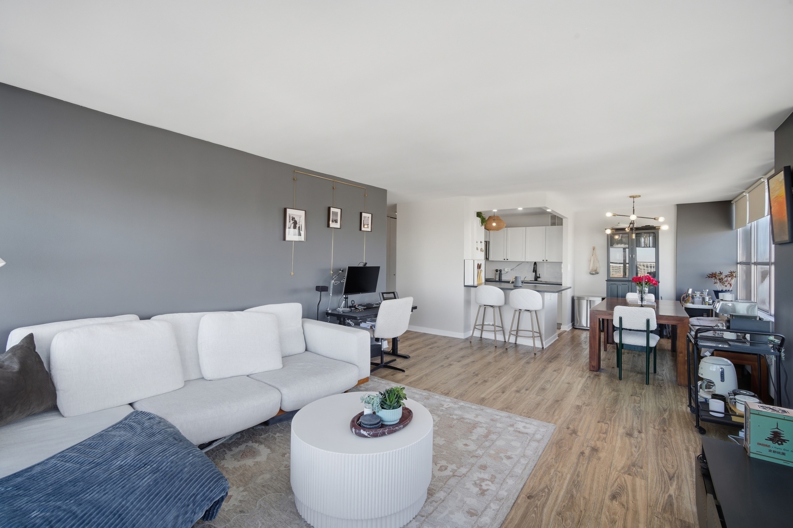 655 West Irving Park Road, Unit 2916 Chicago, IL 60613 - Photo 5 of 28 a living room with furniture and wooden floor