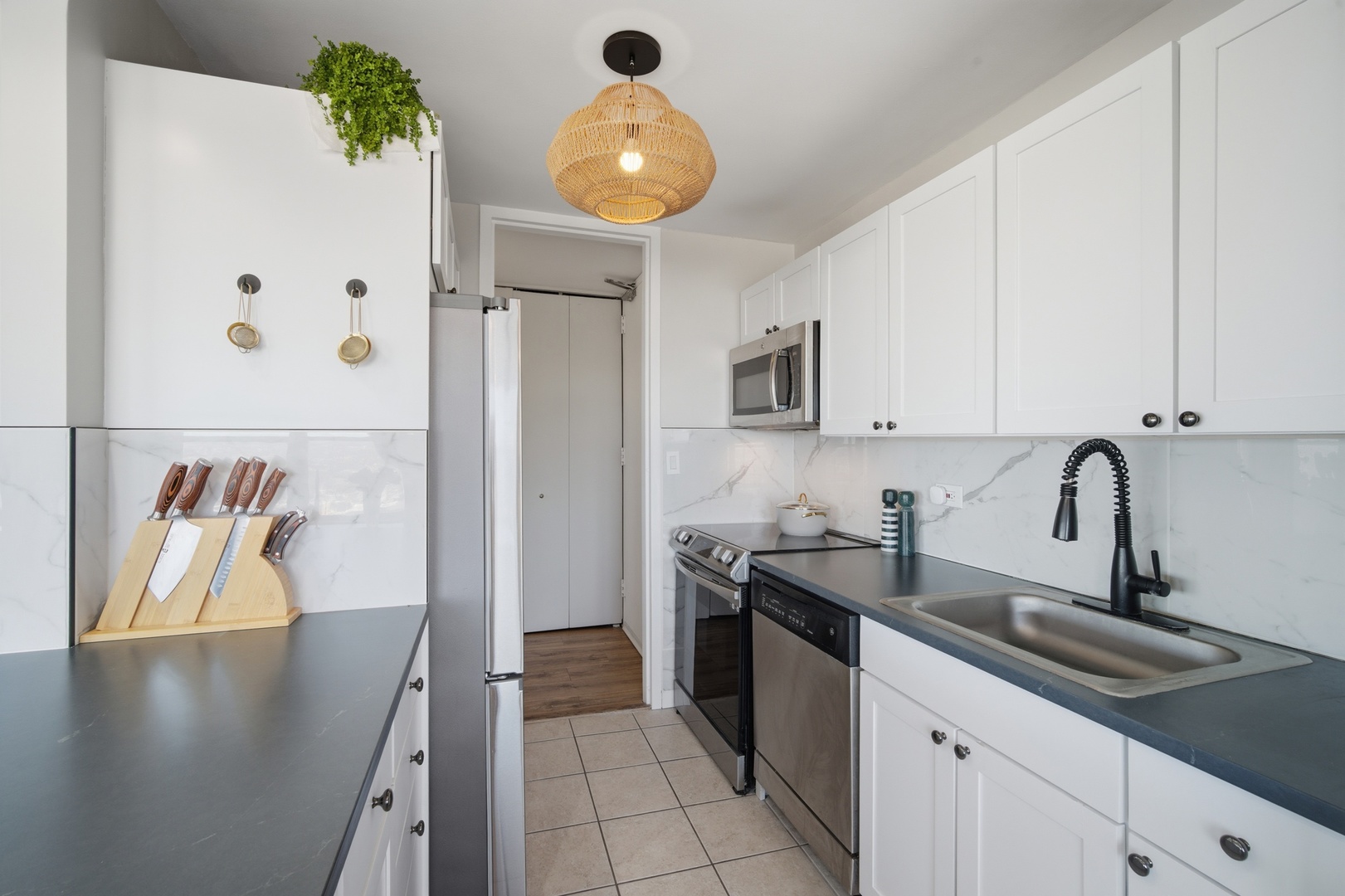 655 West Irving Park Road, Unit 2916 Chicago, IL 60613 - Photo 6 of 28 a kitchen with stainless steel appliances granite countertop a sink a stove and cabinets