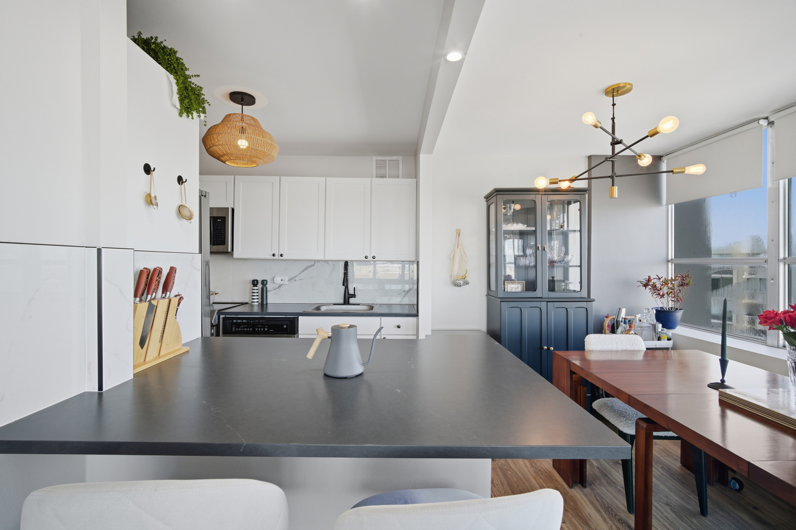 655 West Irving Park Road, Unit 2916 Chicago, IL 60613 - Photo 7 of 28 a view of a dining room with furniture and wooden floor