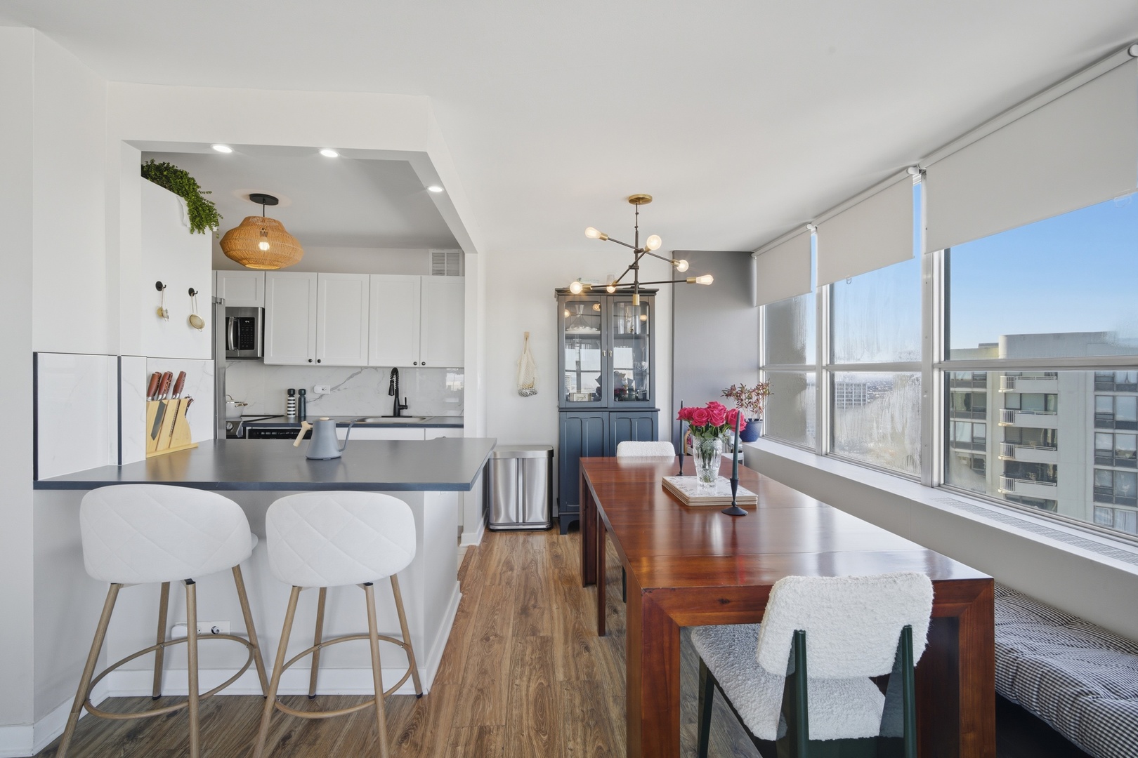 655 West Irving Park Road, Unit 2916 Chicago, IL 60613 - Photo 9 of 28 a view of a dining room with furniture window and wooden floor