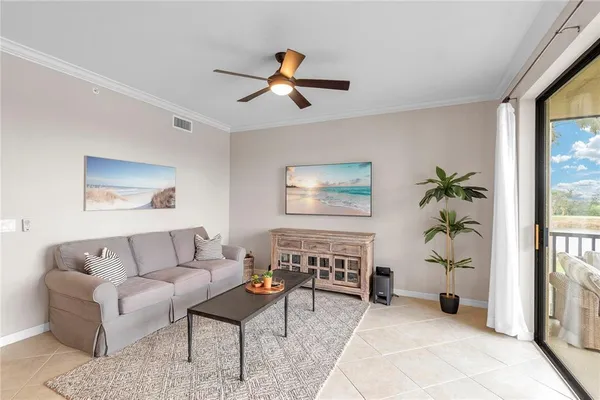 a living room with furniture and a potted plant