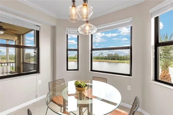a dining room with furniture a chandelier and wooden floor