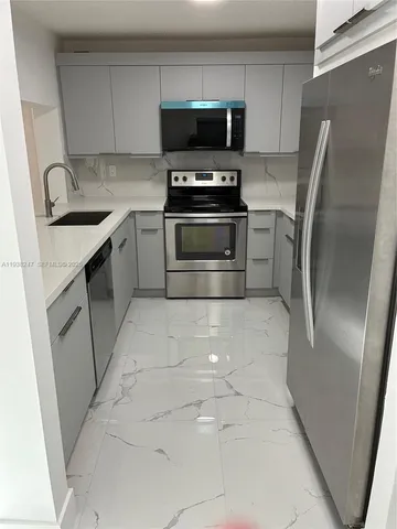 a kitchen with a stove and a microwave