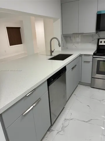 a kitchen with white cabinets and a stove
