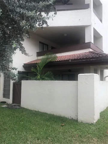 a view of a patio with table and chairs with wooden floor and fence
