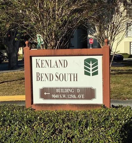 a view of a house with a wooden fence