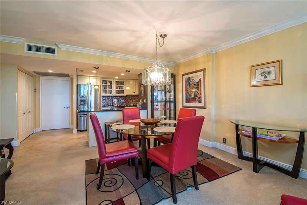 3 Bluebill Avenue, Unit 704 Naples, FL 34108 - Photo 6 of 12 a dining room with furniture and window