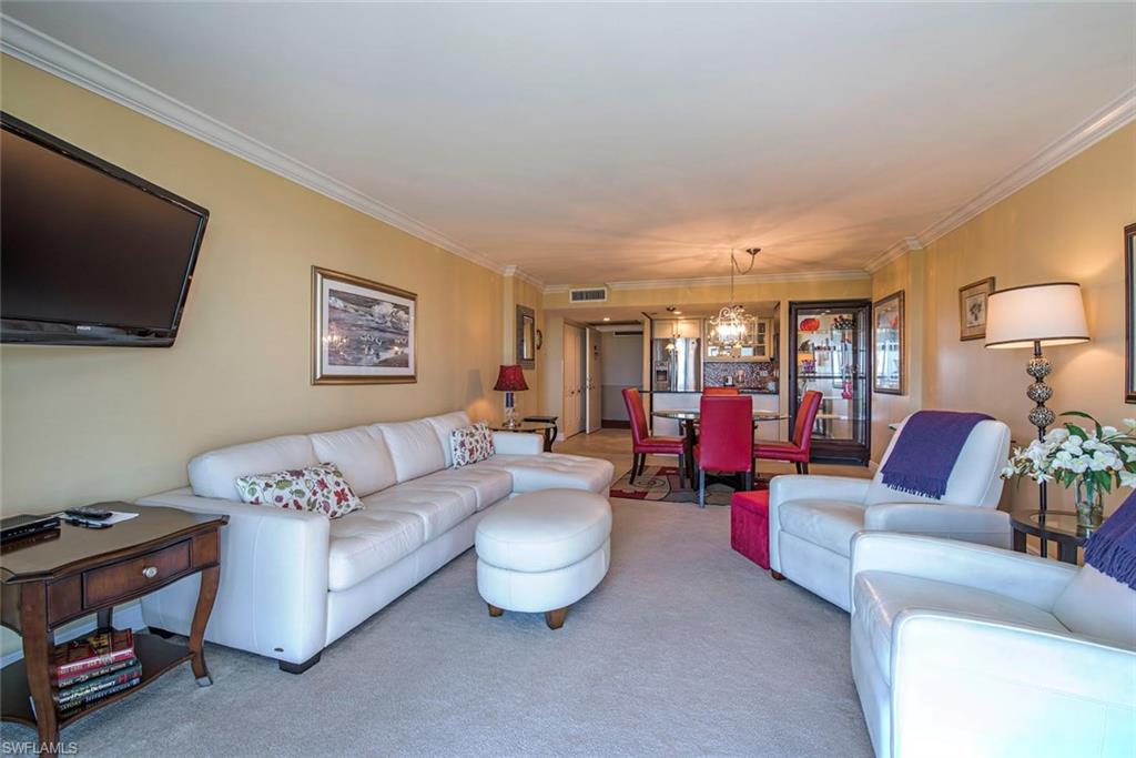 3 Bluebill Avenue, Unit 704 Naples, FL 34108 - Photo 7 of 12 a living room with furniture and a flat screen tv