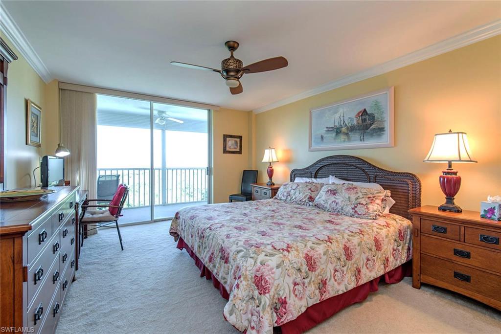 3 Bluebill Avenue, Unit 704 Naples, FL 34108 - Photo 8 of 12 a bedroom with a bed and a large window