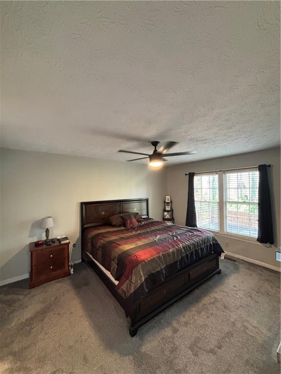 4949 Penscot Way Stone Mountain, GA 30088 - Photo 29 of 40 a spacious bedroom with a bed and window