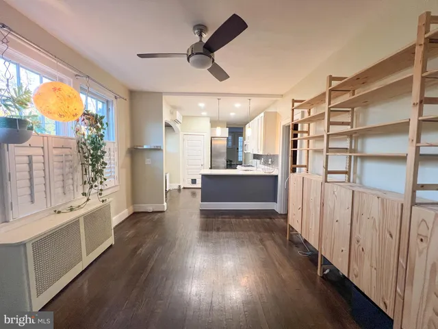 a view of a big room with wooden floor and windows