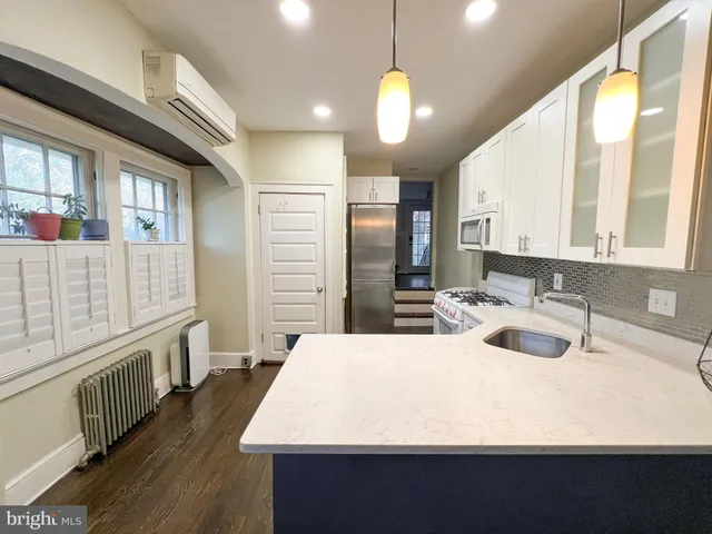 a bathroom with a sink and a large mirror
