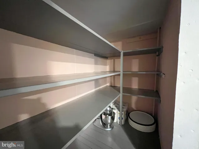 a view of a room with wooden floor and chairs