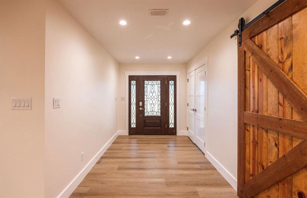 4505 Harrison Street Bellmead, TX 76705 - Photo 13 of 39 a view of a hallway with wooden floor and staircase