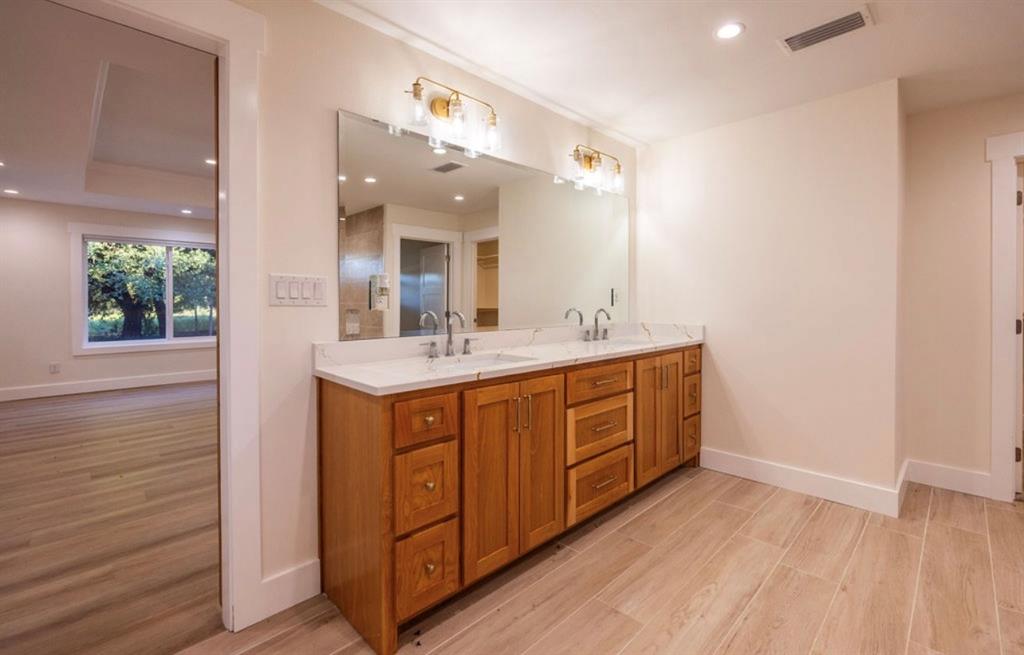 4505 Harrison Street Bellmead, TX 76705 - Photo 18 of 39 a bathroom with a double vanity sink and a mirror