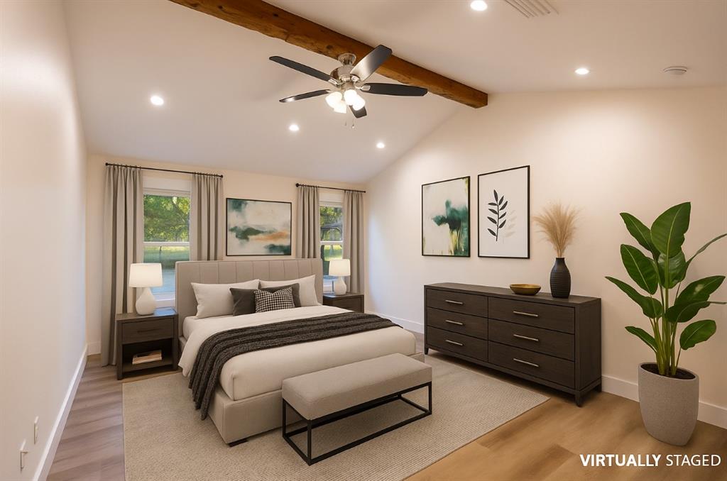 4505 Harrison Street Bellmead, TX 76705 - Photo 21 of 39 a bedroom with a large bed and a potted plant