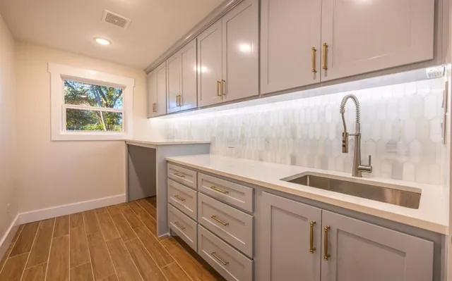 a kitchen with a sink and cabinets