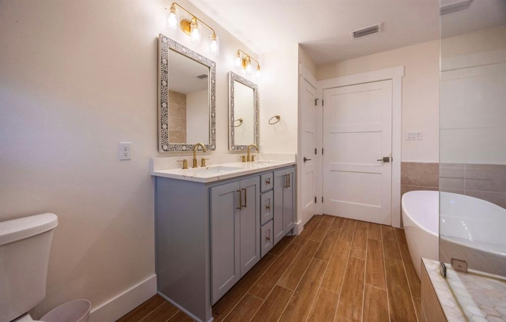4505 Harrison Street Bellmead, TX 76705 - Photo 25 of 39 a bathroom with a sink a toilet a mirror and shower
