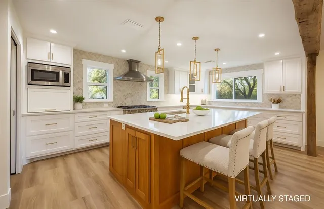 a kitchen with a table chairs stove and microwave