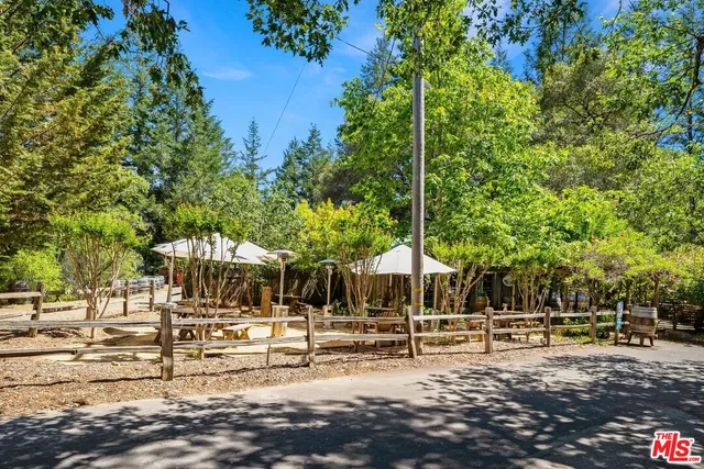 a view of a yard with wooden fence