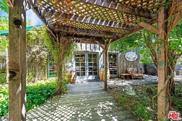 a living room with furniture a flat screen tv and a floor to ceiling window