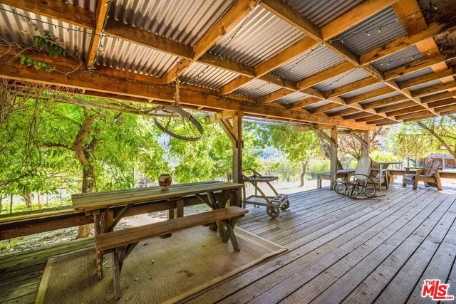a bed sitting in a spacious bedroom next to a window