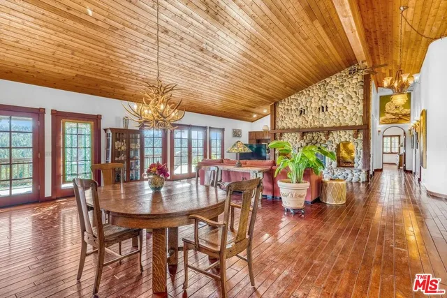a living room with furniture windows and wooden floor