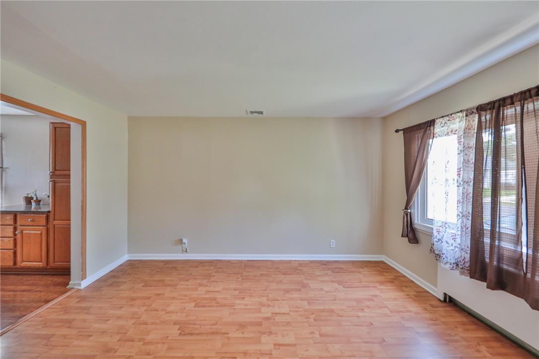 3050 Cornwall Road Bethlehem, PA 18017 - Photo 11 of 80 Laminate wood flooring extends throughout this versatile living area, offering a clean, adaptable space.