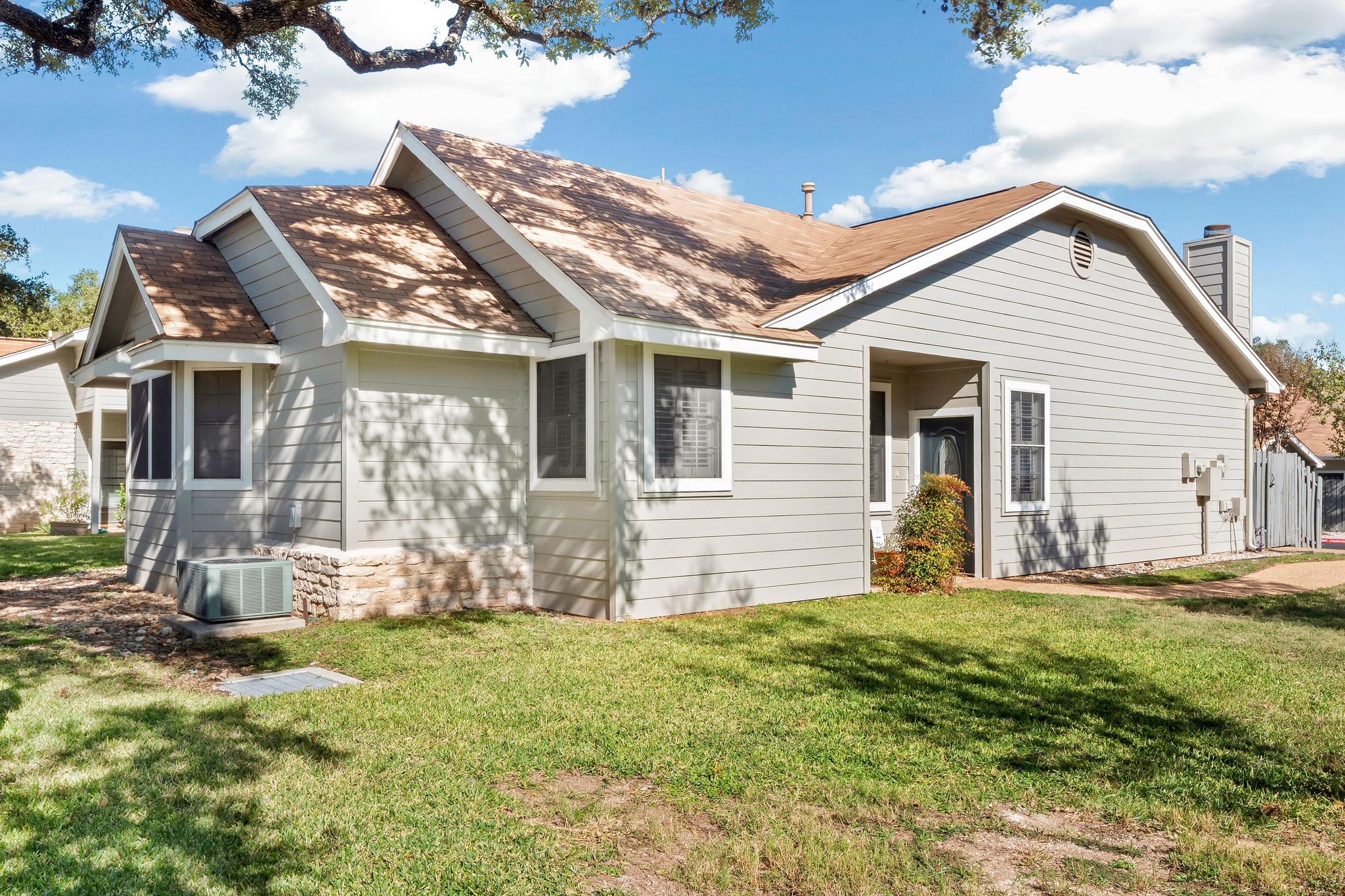6501 Brush Country Road, Unit 109 Austin, TX 78749 - Photo 1 of 26 a view of a house with a yard and sitting area