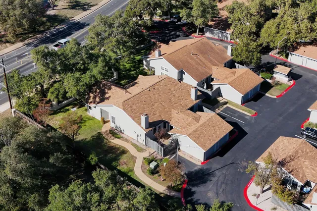 a backyard of a house with table and chairs