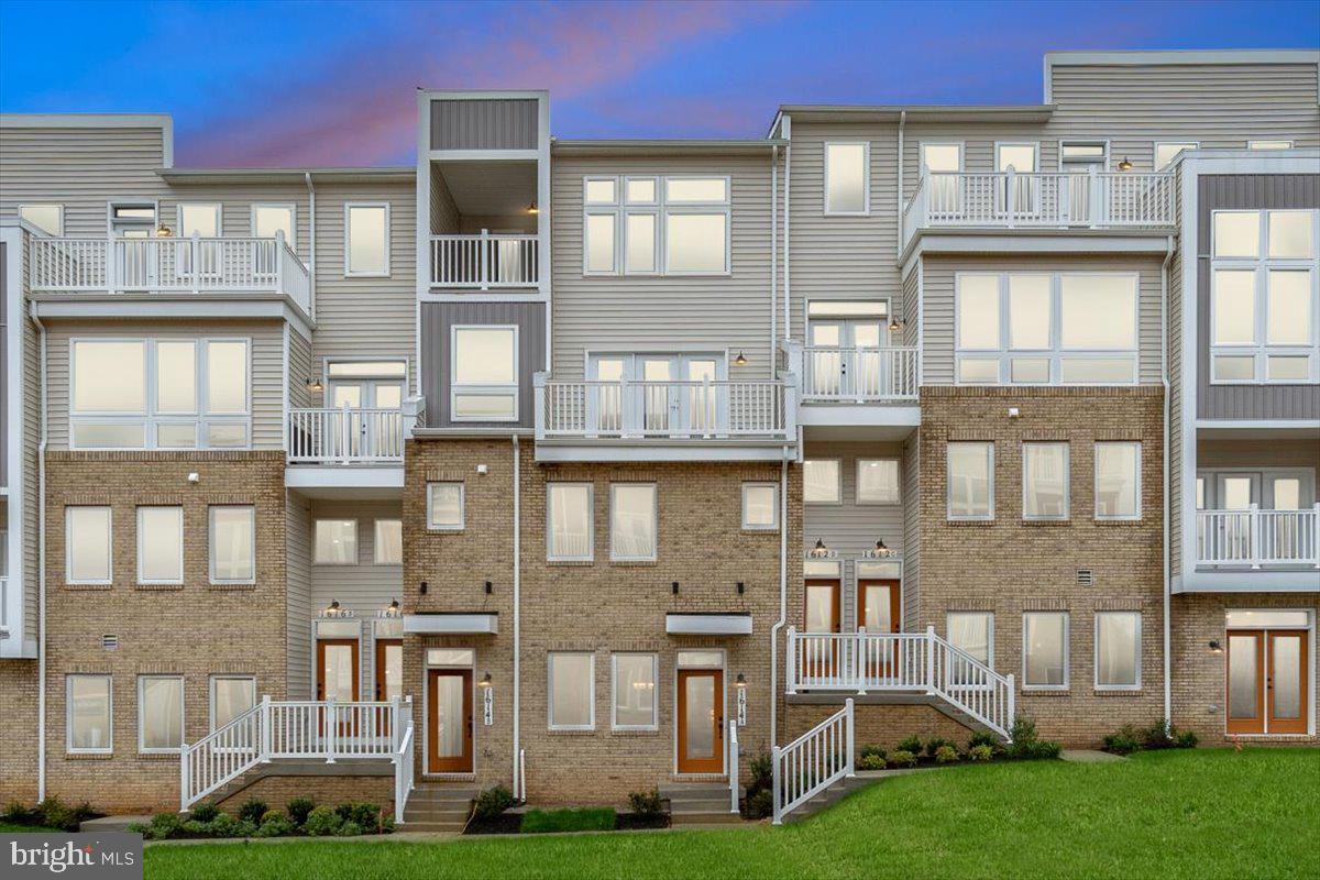 a front view of a residential apartment building with a yard