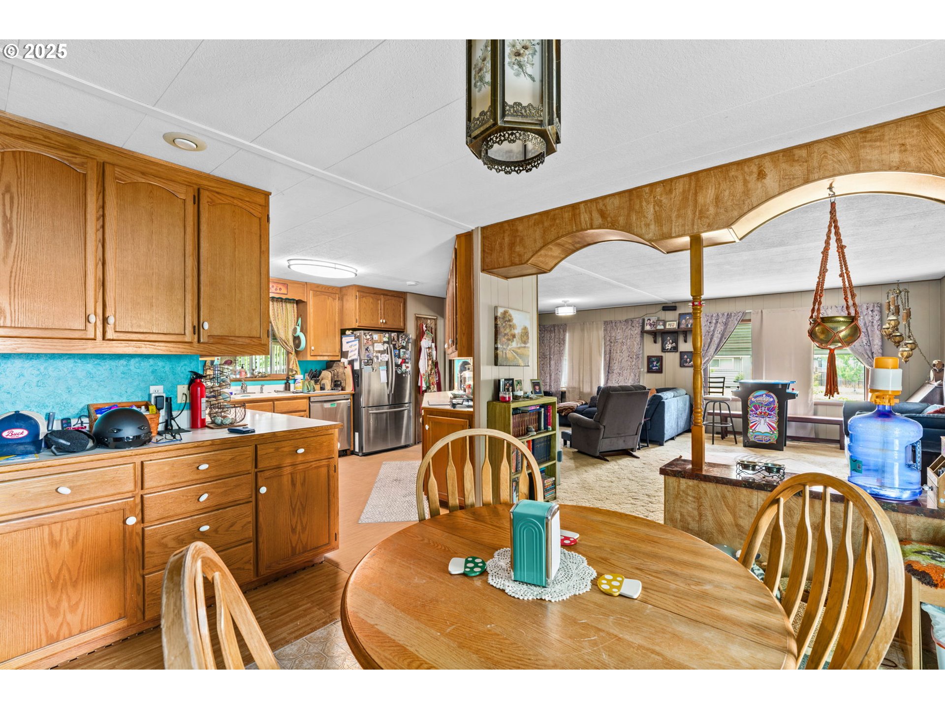 2484 Devon Avenue Eugene, OR 97408 - Photo 12 of 22 a living room with lots of chairs and a dining table with chandelier