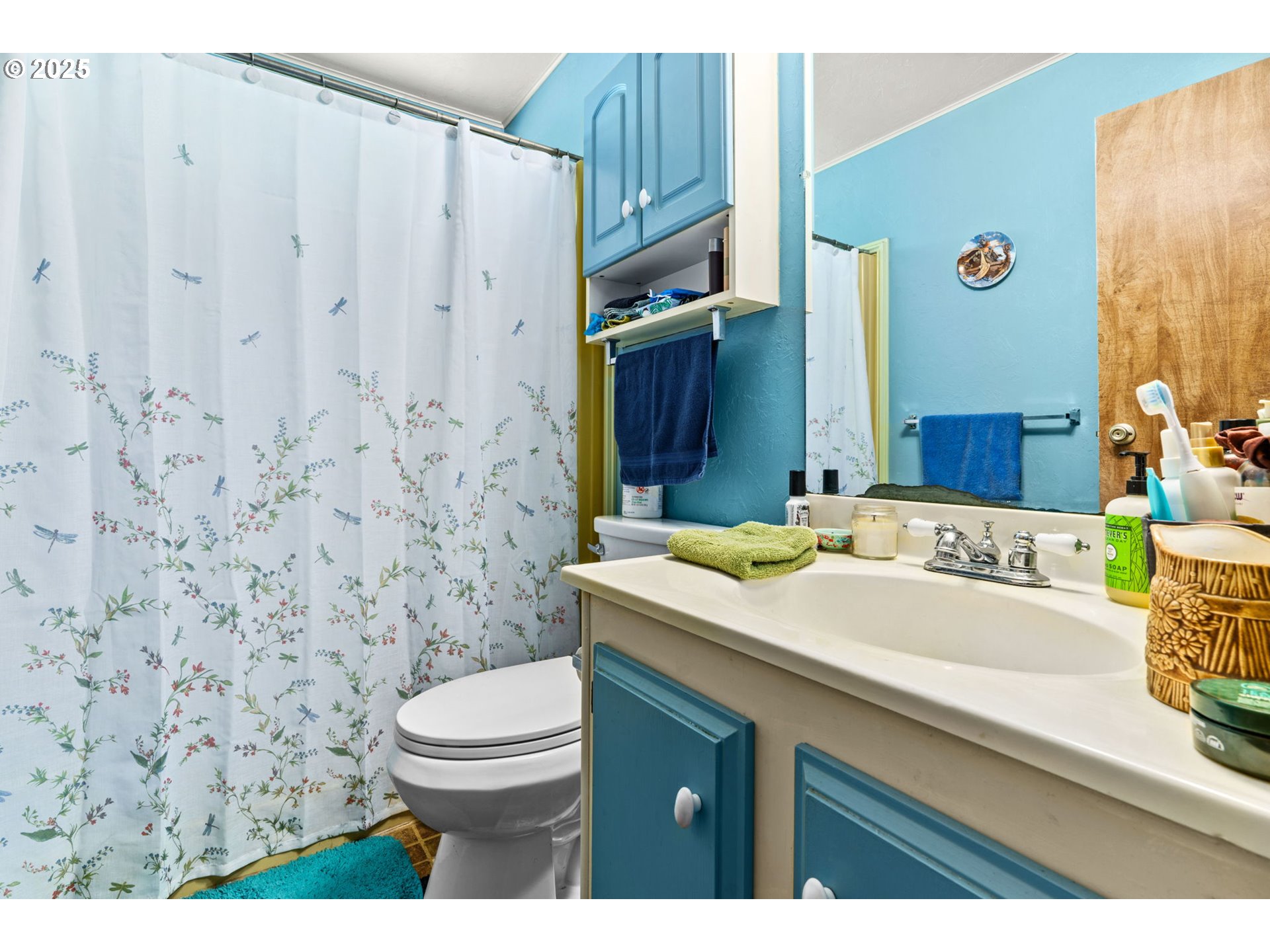 2484 Devon Avenue Eugene, OR 97408 - Photo 13 of 22 a bathroom with a granite countertop sink a toilet and a mirror