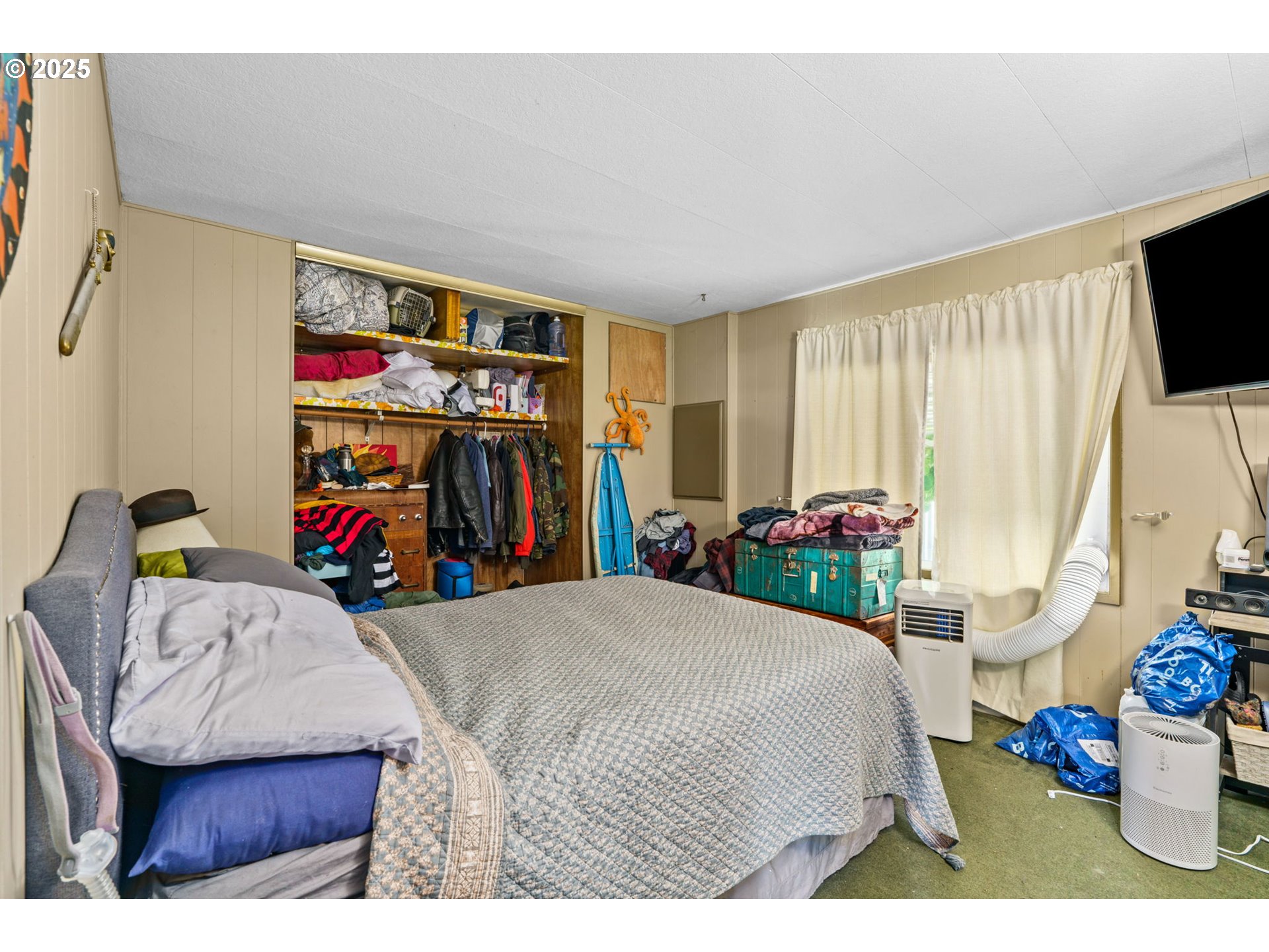 2484 Devon Avenue Eugene, OR 97408 - Photo 14 of 22 a bedroom with a bed a dresser and a flat screen tv