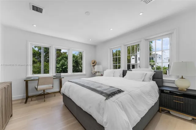 a bedroom with a large bed and a window