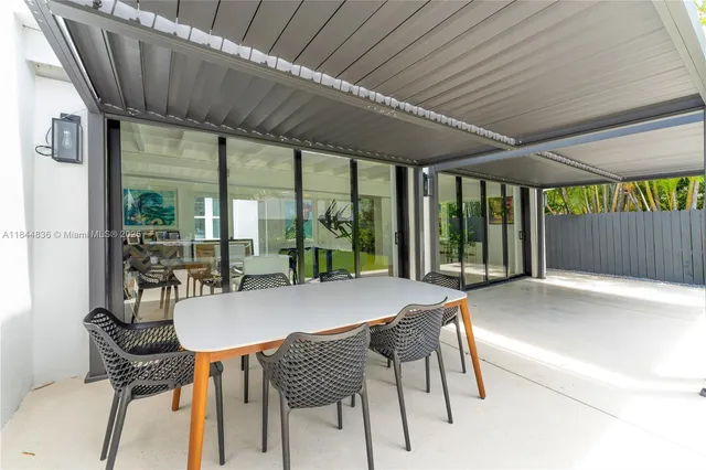 a view of backyard with swimming pool and outdoor seating