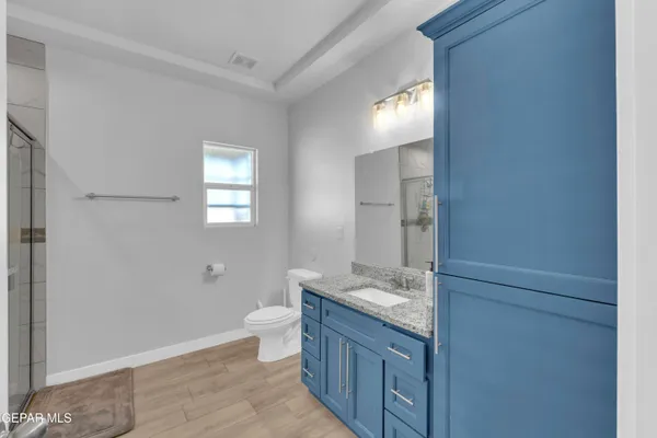 a bathroom with a granite countertop sink toilet and shower