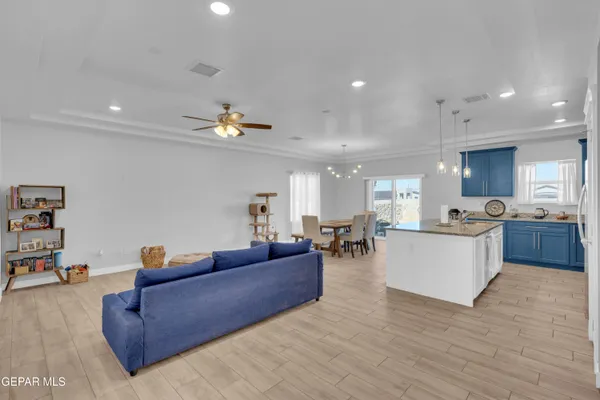 a living room with furniture and kitchen view