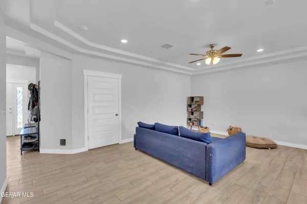 a living room with furniture and a wooden floor