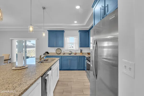 a kitchen with stainless steel appliances granite countertop a refrigerator a sink and dishwasher