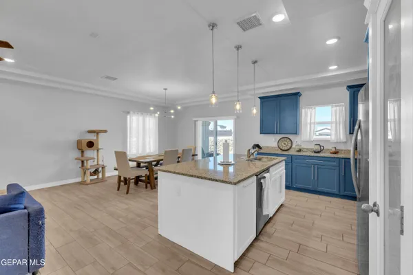 a kitchen with stainless steel appliances kitchen island granite countertop a sink and cabinets