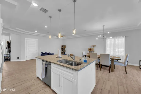 a kitchen with a sink a counter space and a dining table