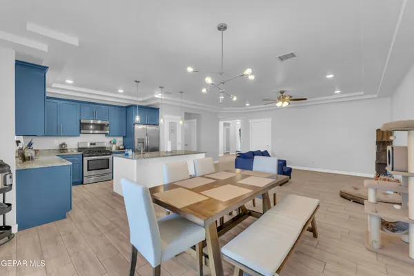 a living room with stainless steel appliances kitchen island granite countertop furniture a kitchen island a sink and a refrigerator