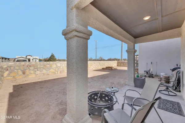 a view of a patio and fire pit