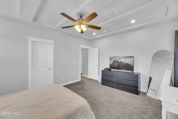 a bedroom with a bed and a painting on the wall