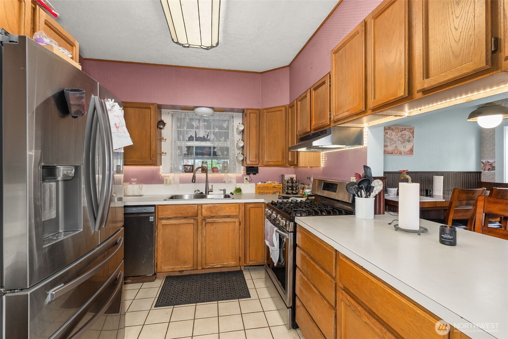 535 Southwest 19th Street Chehalis, WA 98532 - Photo 12 of 35 a kitchen with stainless steel appliances a sink a stove and a refrigerator