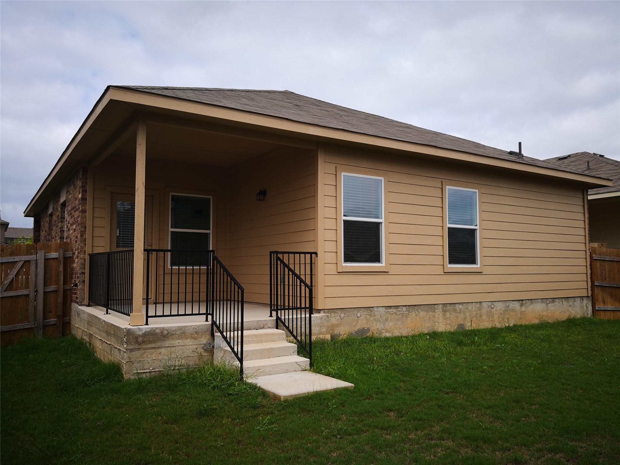 1602 Atlas Road Cedar Park, TX 78613 - Photo 13 of 13 Rear view of property featuring a fenced backyard, covered porch, and a shingled roof
